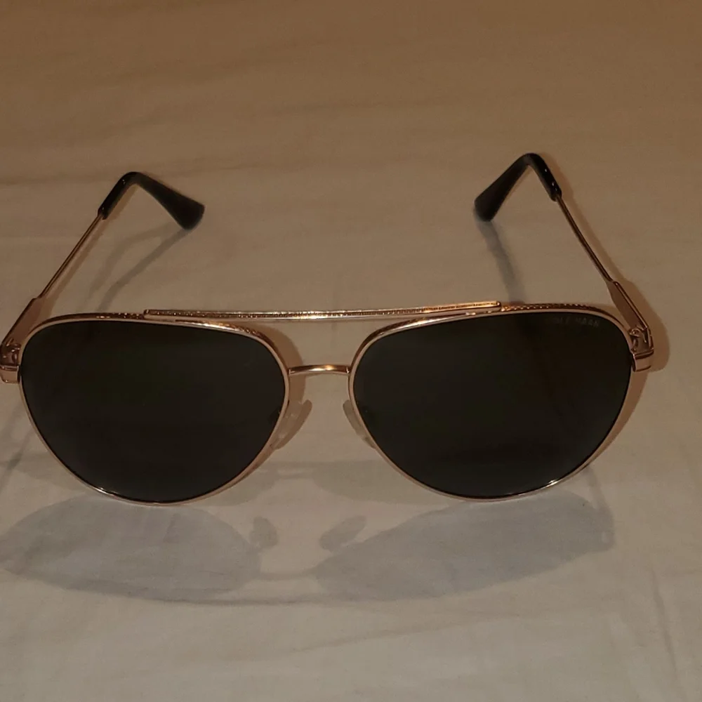Cole Haan gold aviator sunglasses with dark lenses. Polarized.